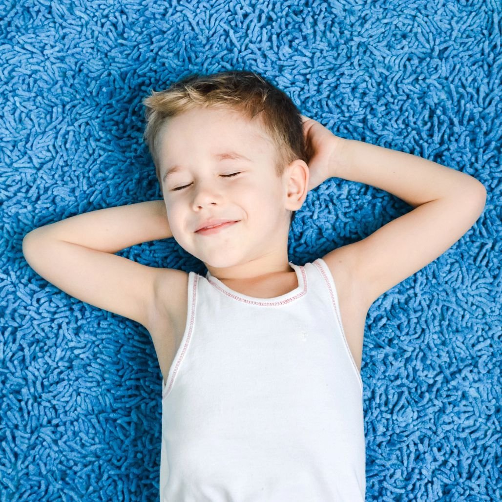 child on blue carpet